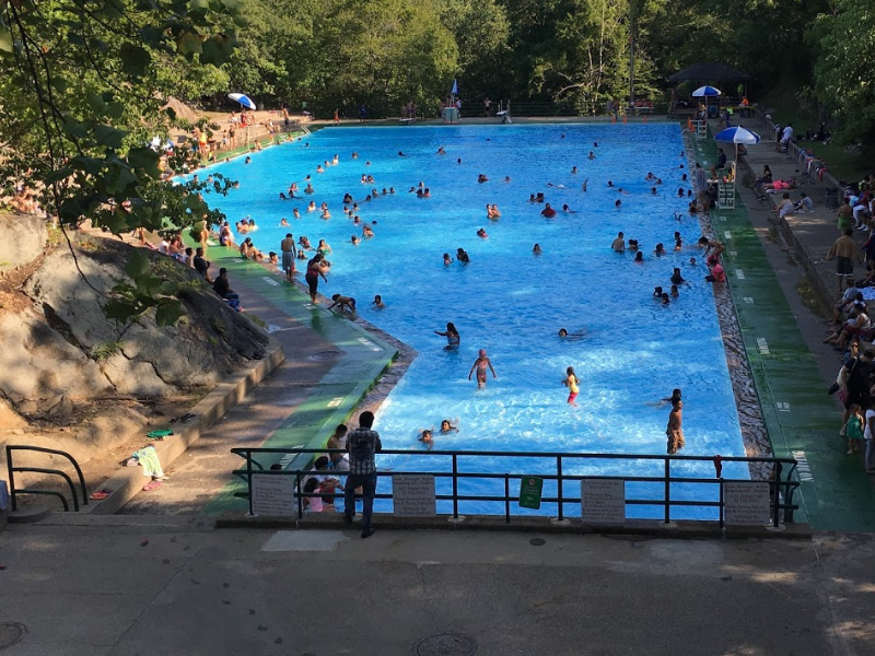 People having fun in a large pool at Bear Mountain Inn